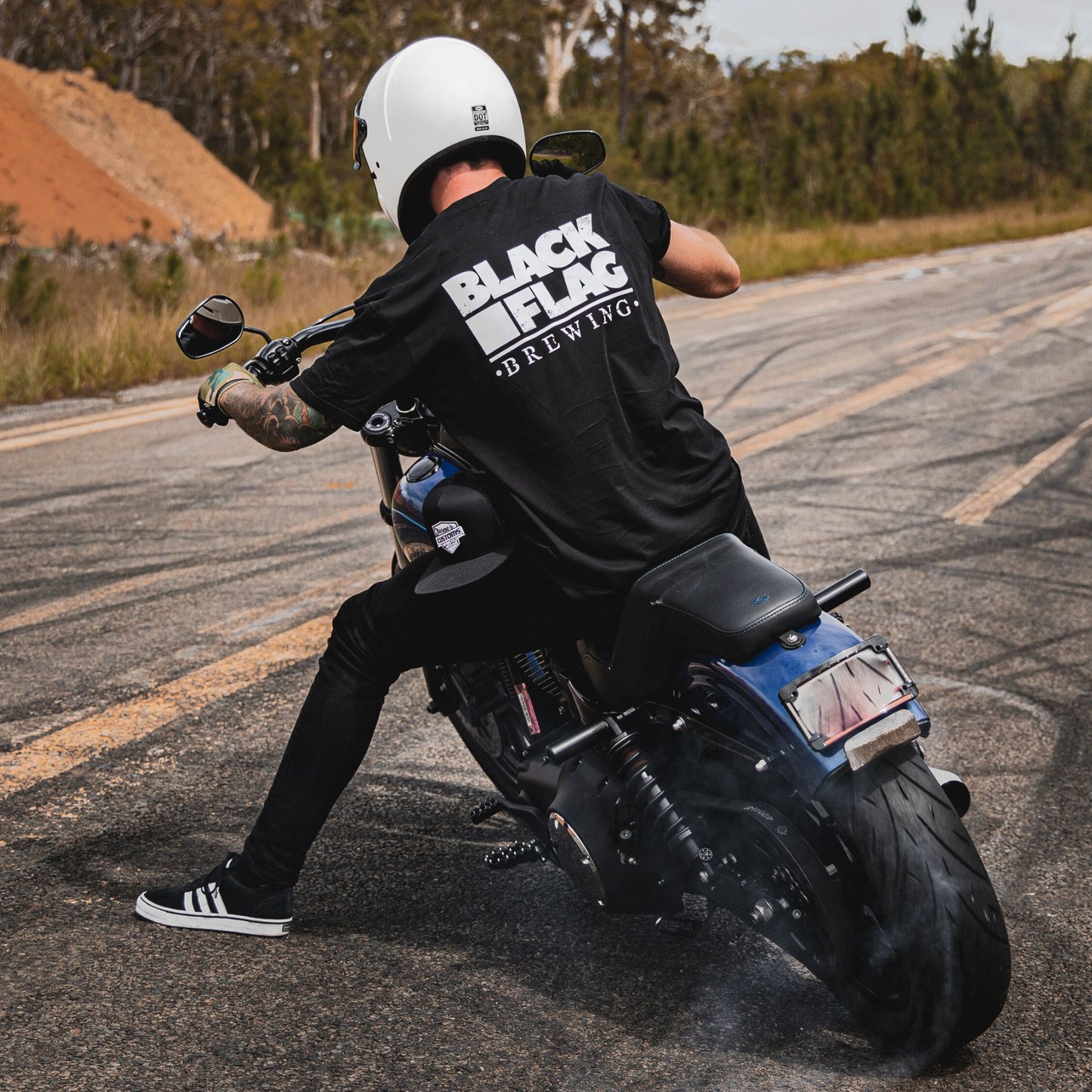 Man on motorcycle wearing Classic Blackflag t-shirt.
