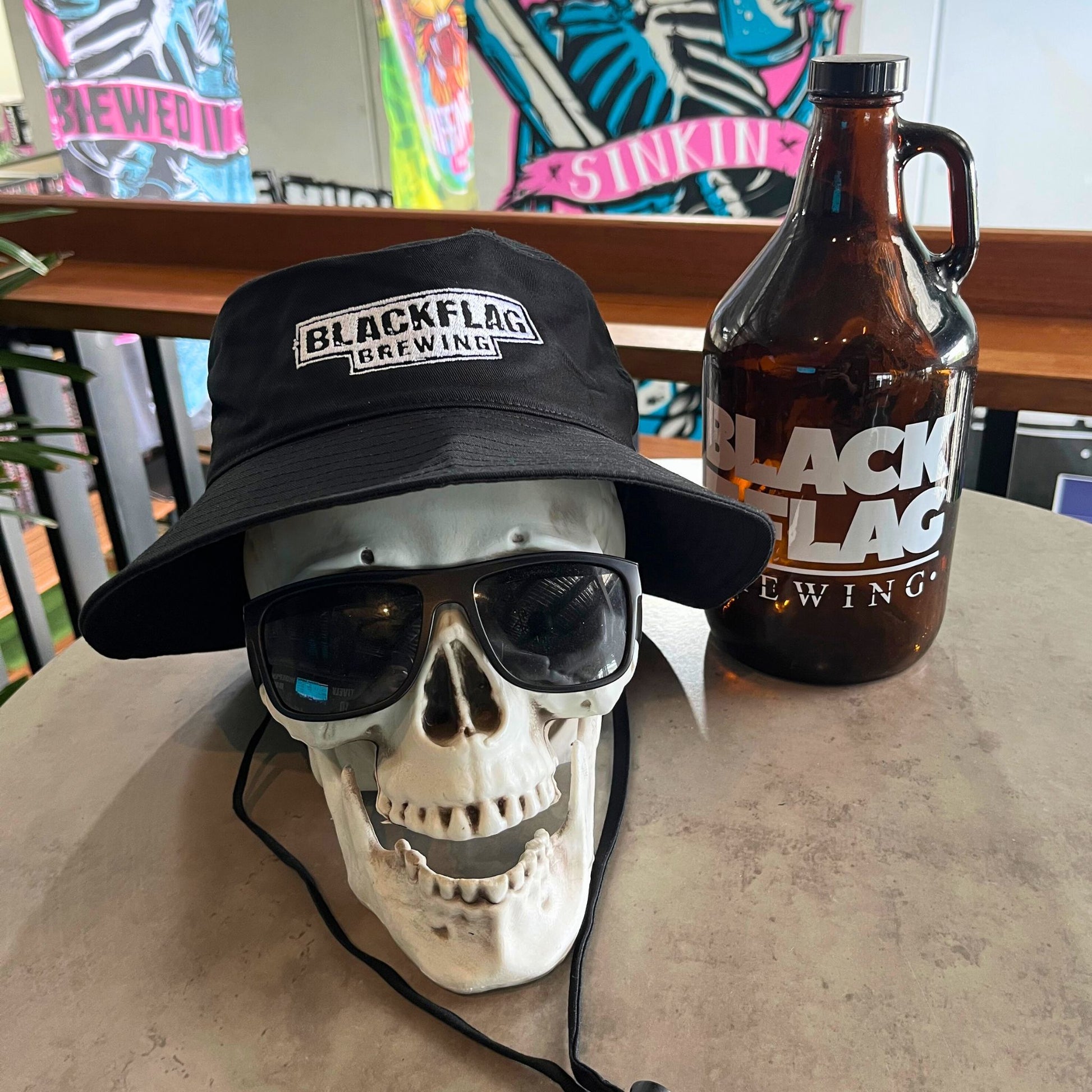 Blackflag wide brim bucket hat with white Blackflag Brewing logo embroidered on the front.